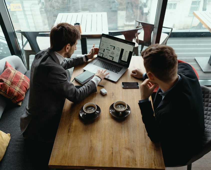 Two young businessman having a successful meeting at restaurant.